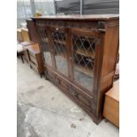 A JAYCEE STYLE OAK BOOKCASE WITH THREE LOWER AND THREE UPPER GLAZED DOOR