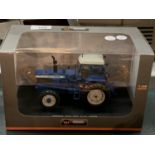 A BOXED UNIVERSAL HOBBIES DIE CAST FORD TRACTOR 1:32