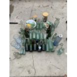 AN ASSORTMENT OF CERAMIC AND GLASS WARE TO INCLUDE A QUANTITY OF GREEN GLASS BOTTLES