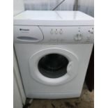 A WHITE HOTPOINT WASHING MACHINE BELIEVED IN WORKING ORDER BUT NO WARRANTY