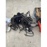 AN ASSORTMENT OF HORSE TACK TO INCLUDE BRIDLES AND HEAD COLLARS