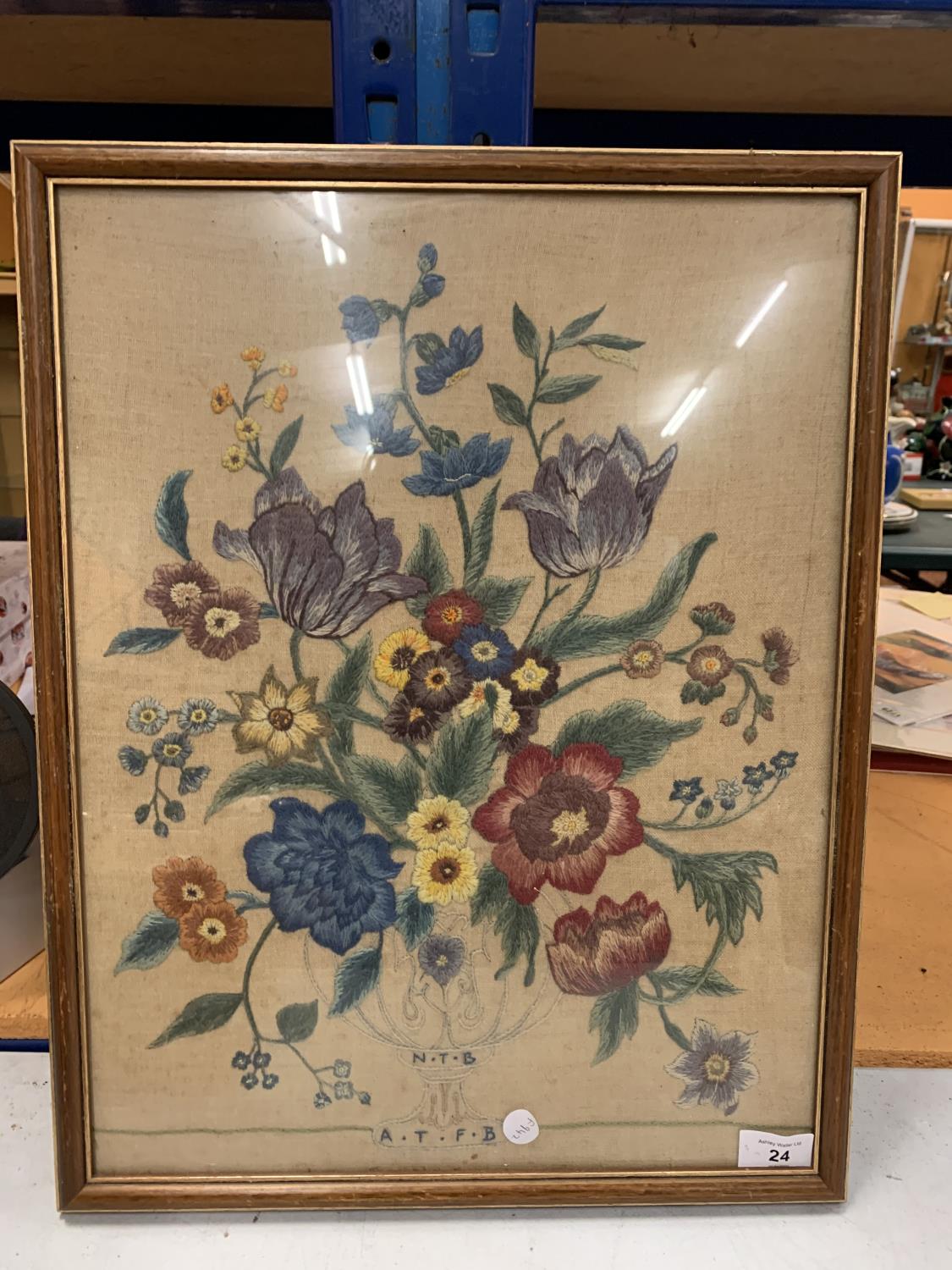 A FRAMED NEEDLEWORK OF FLOWERS 49CM X 37CM