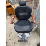 A MODERN BARBERS CHAIR WITH ADJUSTABLE MECHANISM, ON CIRCULAR FEET