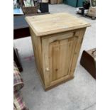 A SMALL PINE SINGLE DOOR CUPBOARD - 21" WIDE