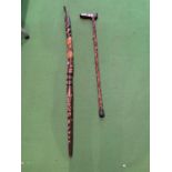 A CARVED WOODEN WALKING STICK FEATURING A CAT HANDLE AND A WOODEN SNAKE HANDLE WALKING STICK WITH