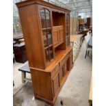 A LARGE YOUNGER CABINET WITH FOUR LOWER DOORS AND THREE DRAWERS AND FOUR UPPER DOORS