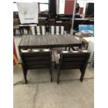 A FOUR SEATER WOODEN GARDEN TABLE WITH FOUR CHAIRS COMPLETE WITH CUSHIONS