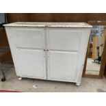 A VINTAGE WHITE PAINTED WOODEN STORAGE UNIT WITH TEN SHELVES INSIDE (H:134CM W:152 D:48CM)