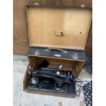 A VINTAGE SINGER SEWING MACHINE IN CARRY CASE