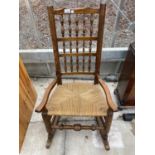 AN 18TH CENTURY STYLE LANCASHIRE SPINDLE BACK ROCKING CHAIR WITH RUSH SEAT