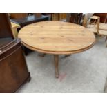 A MODERN CIRCULAR PINE TABLE ON TRIPOD BASE, 54" DIAMETER