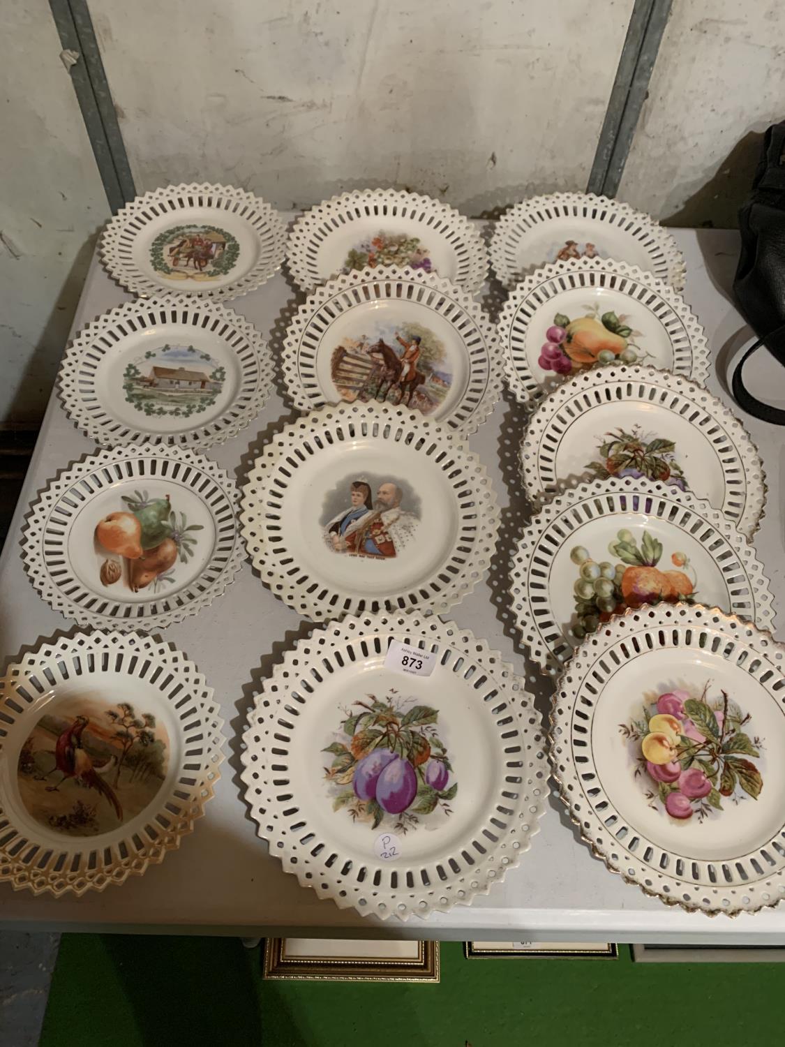 A COLLECTION OF CERAMIC PLATES WITH DECORATIVE OUTER EDGING