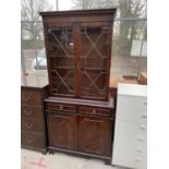 A REPRODUCTION MAHOGANY ASTRAGAL GLAZED BOOKCASE WITH CUPBOARDS TO THE BASE, DENTIL CORNICE, 33"