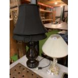 A LARGE METAL TABLE LAMP WITH TWO BLACK SHADES AND A WOODEN BASED TABLE LAMP WITH GRAPES AND FRUIT