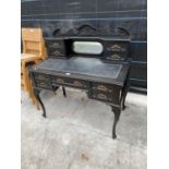 A LATE VICTORIAN EBONISED LADIES' WRITING TABLE WITH MIRRORED BACK AND INSET LEATHER WRITING SURFACE