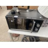 A BLACK RUSSELL HOBBS MICROWAVE OVEN BELIEVED IN WORKING ORDER BUT NO WARRANTY