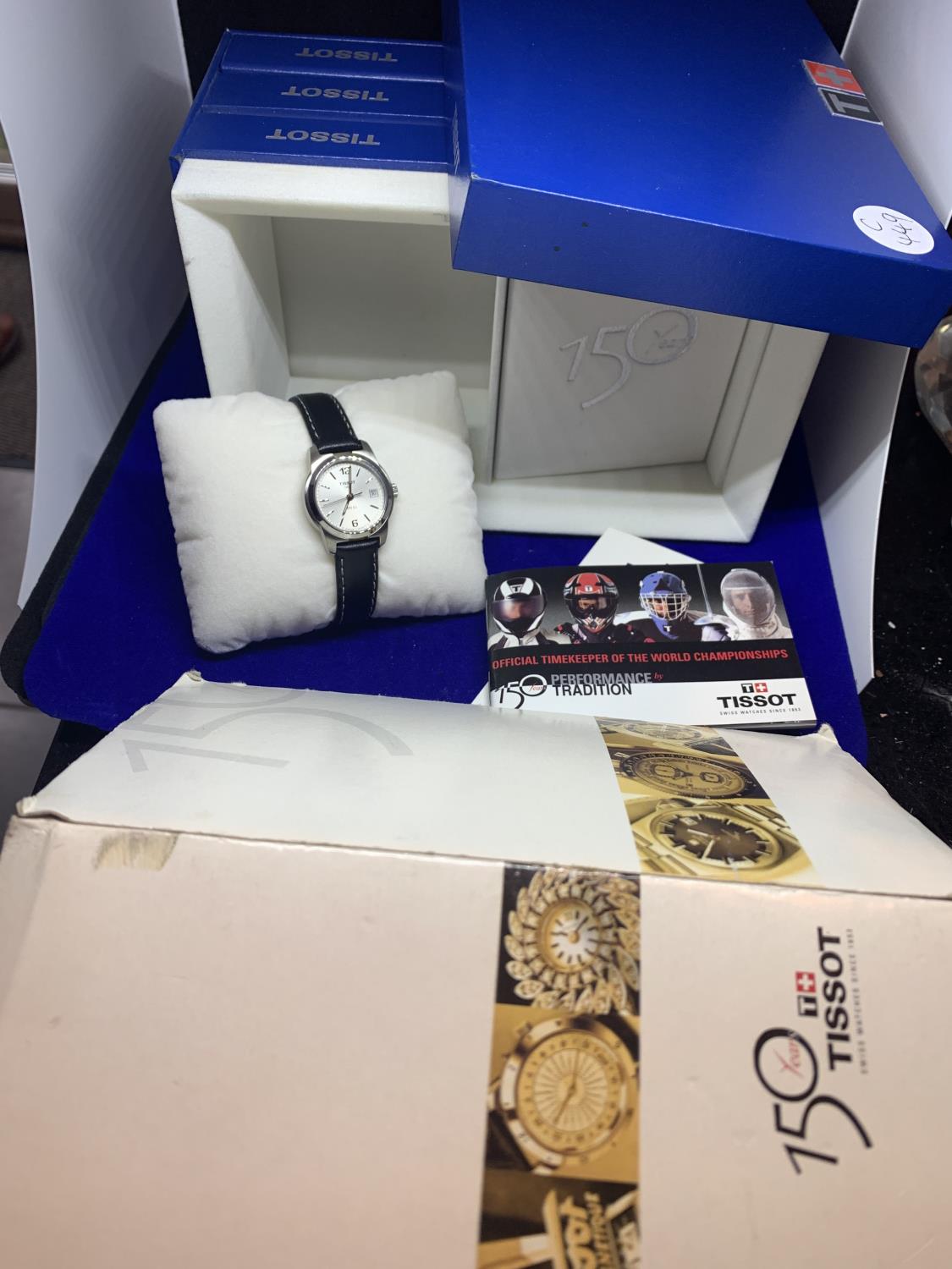 A TISSOT 150 YEARS LADIES WATCH IN PRESENTATION BOX WITH THE HISTORY OF TISSOT BOOK ETC