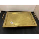 A RECTANGULAR TWIN HANDLED BRASS TRAY