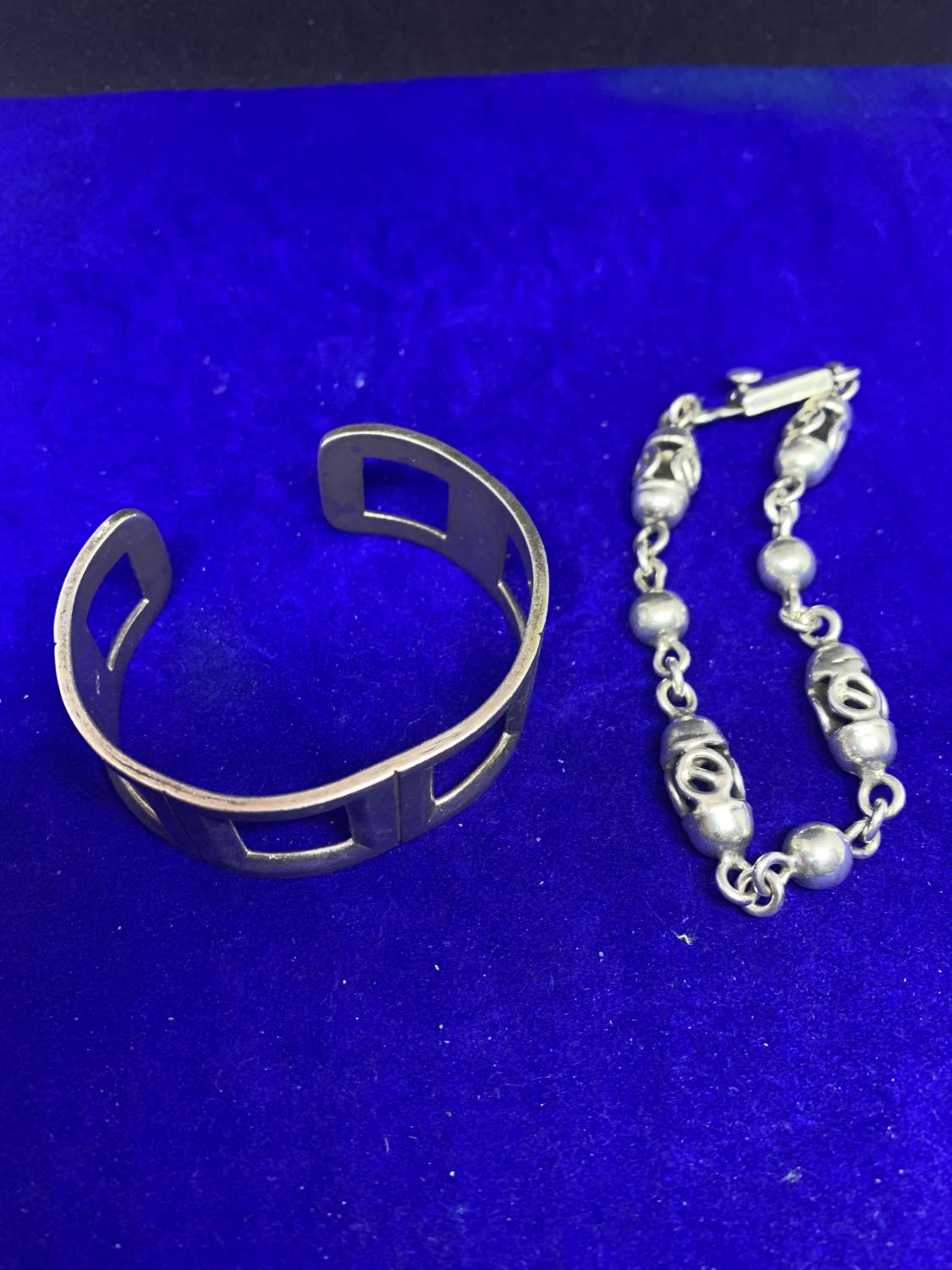 TWO HEAVY SILVER BRACELETS MARKED 925 TO INCLUDE A BANGLE AND A CELTIC STYLE