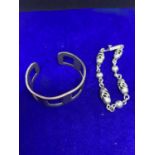 TWO HEAVY SILVER BRACELETS MARKED 925 TO INCLUDE A BANGLE AND A CELTIC STYLE