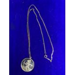 A SILVER ST CHRISTOPHER PENDANT MARKED SILVER ON A CHAIN