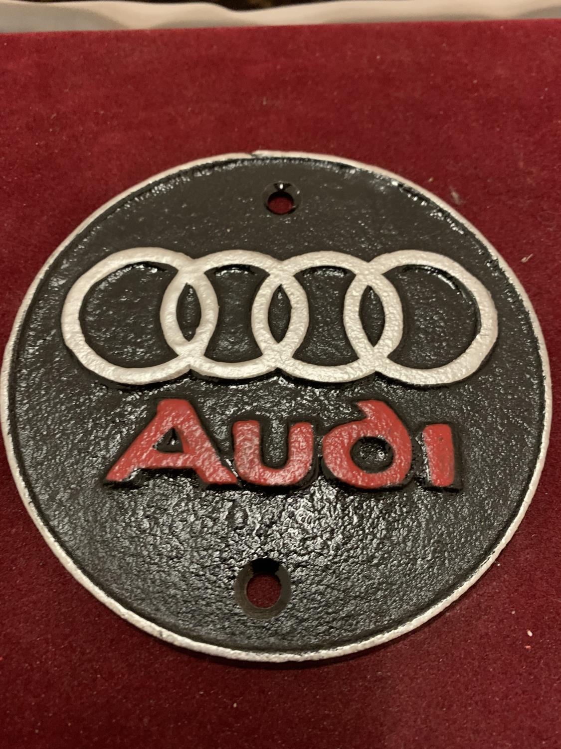 A CAST METAL "AUDI" CIRCULAR SIGN