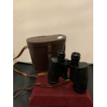 A PAIR OF LEATHER CASED 10X50 FIELD BINOCULARS