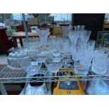 A LARGE ASSORTMENT OF GLASS WARE TO INCLUDE SERVING DISHES AND WINE GLASSES ETC