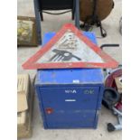 A LOCKABLE METAL STORAGE CUPBOARD (NO KEY) AND A METAL ROAD SIGN