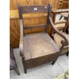 A 19TH CENTURY OAK COMMODE CHAIR (LACKING CHAMBER POT)