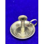 A WHITE METAL MINATURE CANDLESTICK POSSIBLY SILVER