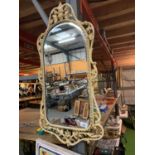 A ORNATE CREAM AND GILT FRAMED WALL MIRROR