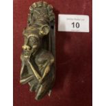 A SMALL BRASS DOOR KNOCKER IN THE FORM OF AN IMP