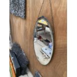 AN OVAL BEVELED EDGE ART DECO MIRROR