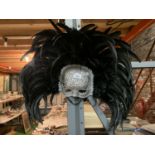 A MASQUERADE MASK WITH FEATHERS