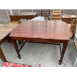 AN EDWARDIAN MAHOGANY AND CROSSBANDED TABLE WITH SHAPED ENDS, OVAL INLAY TO THE TOP, ON TAPERED