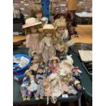 A LARGE COLLECTION OF CHINA DOLLS OF VARYING SIZES