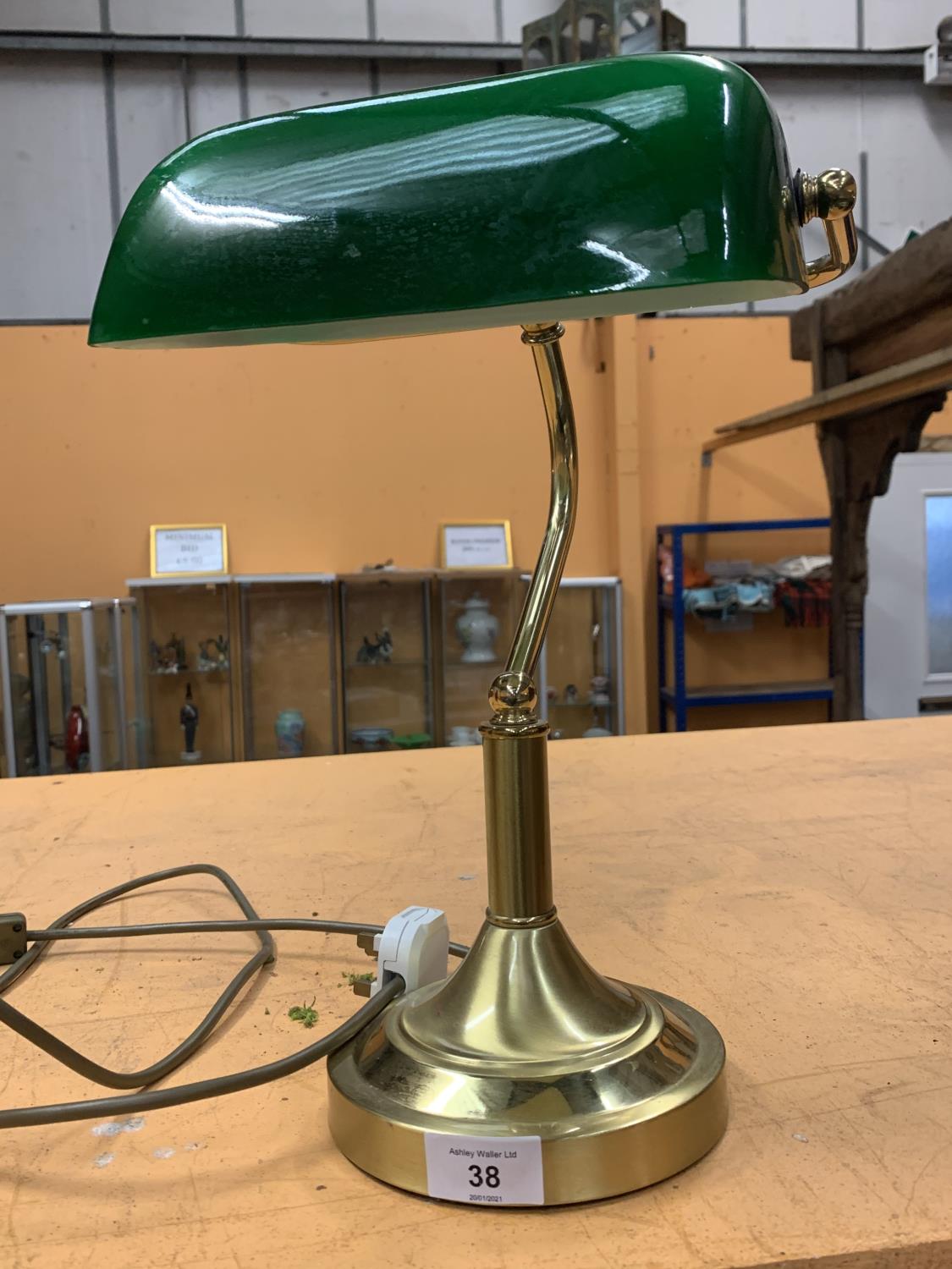 A BRASS BANKERS LAMP WITH GREEN SHADE