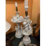 A PAIR OF DECORATIVE WHITE CHINA TABLE LAMPS FEATURING CHERUBS AND FRUIT