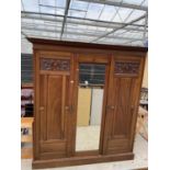 A LATE VICTORIAN MAHOGANY MIRROR DOOR WARDROBE WITH HANGING COMPARTMENT, DRAWERS ANS SLIDES 79