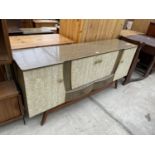 A RETRO CREAMY WALNUT EFFECT SIDEBOARD/COCTAIL CABINET, ENCLOSING FOUR CUPBOARDDS AND TWO DRAWERS,