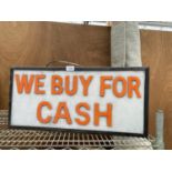 AN ILLUMINATED 'WE BUY FOR CASH' SIGN