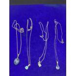 FOUR ASSORTED SILVER NECKLACES MARKED 925 WITH PENDANTS TO INCLUDE STONE EXAMPLES