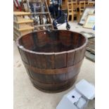 A LARGE HALF BARREL PLANTER