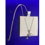 A SILVER NECKLACE WITH A DOLPHIN PENDANT MARKED 925 IN A PRESENTATION BOX