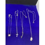 FOUR SILVER NECKLACES MARKED 925 WITH PENDANTS TO INCLUDE A TEDDY, CROSS, CLEAR STONE ETC