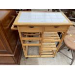 A MODERN PINE KITCHEN ISLAND ON CASTORS WITH WINE RACK AND TILED TOP