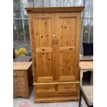 A MODERN PINE TWO DOOR WARDROBE WITH THREE DRAWERS TO THE BASE, 41" WIDE