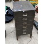 A SMALL SIX DRAWER METAL STORAGE CABINET