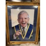 A VERY LARGE GILT FRAMED SIGNED PHOTOGRAPH OF SIR NORMAN WISDOM
